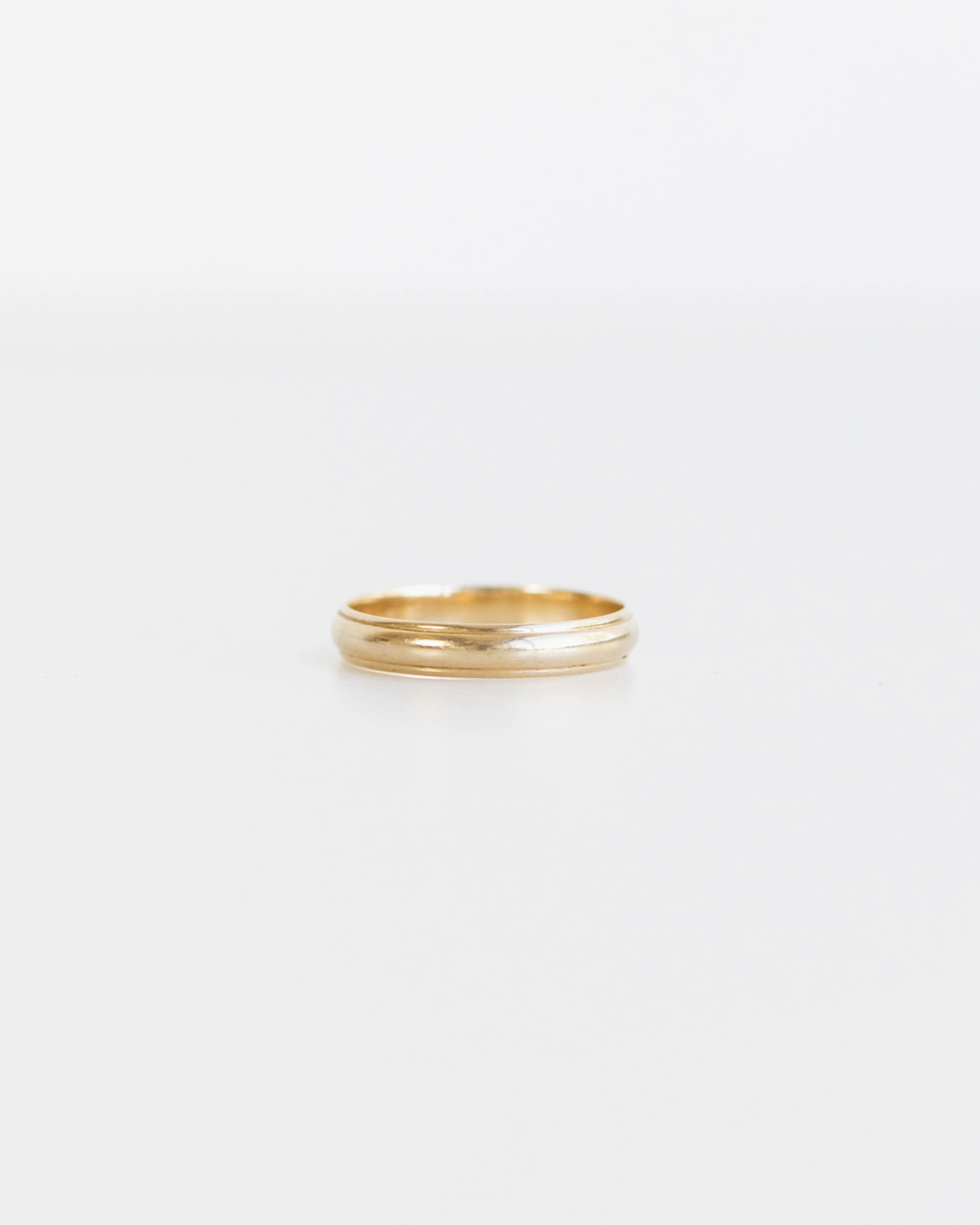 Gold ring on a light gray background