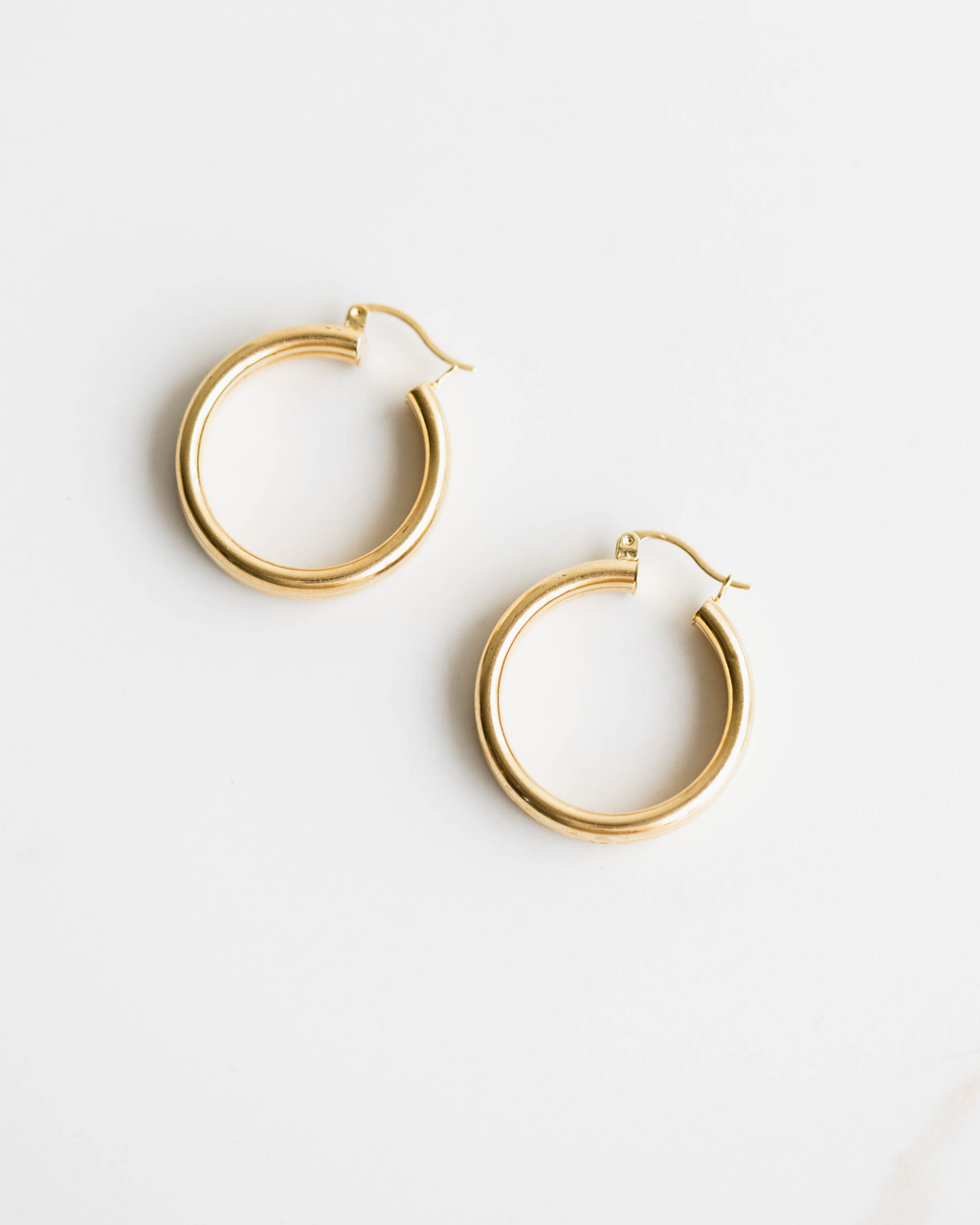 Gold hoop earrings on a white background