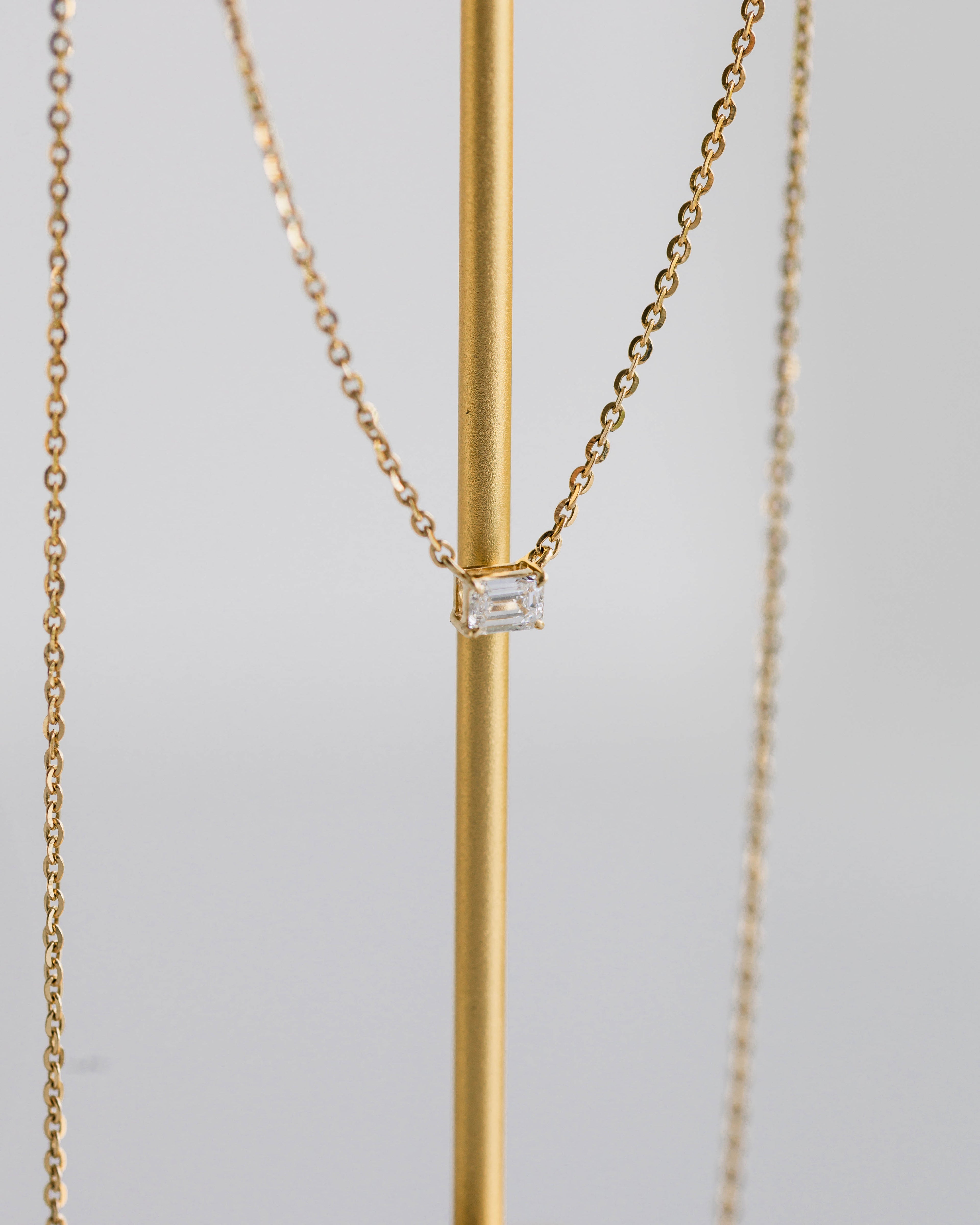 Emerald East-West Pendant — 0.24ctw Yellow Gold